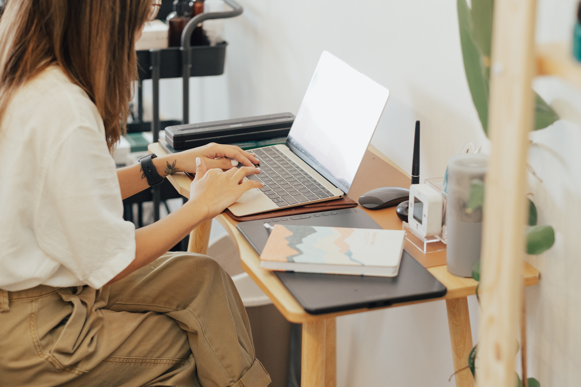 Female Designer Working with Laptop in Studio
